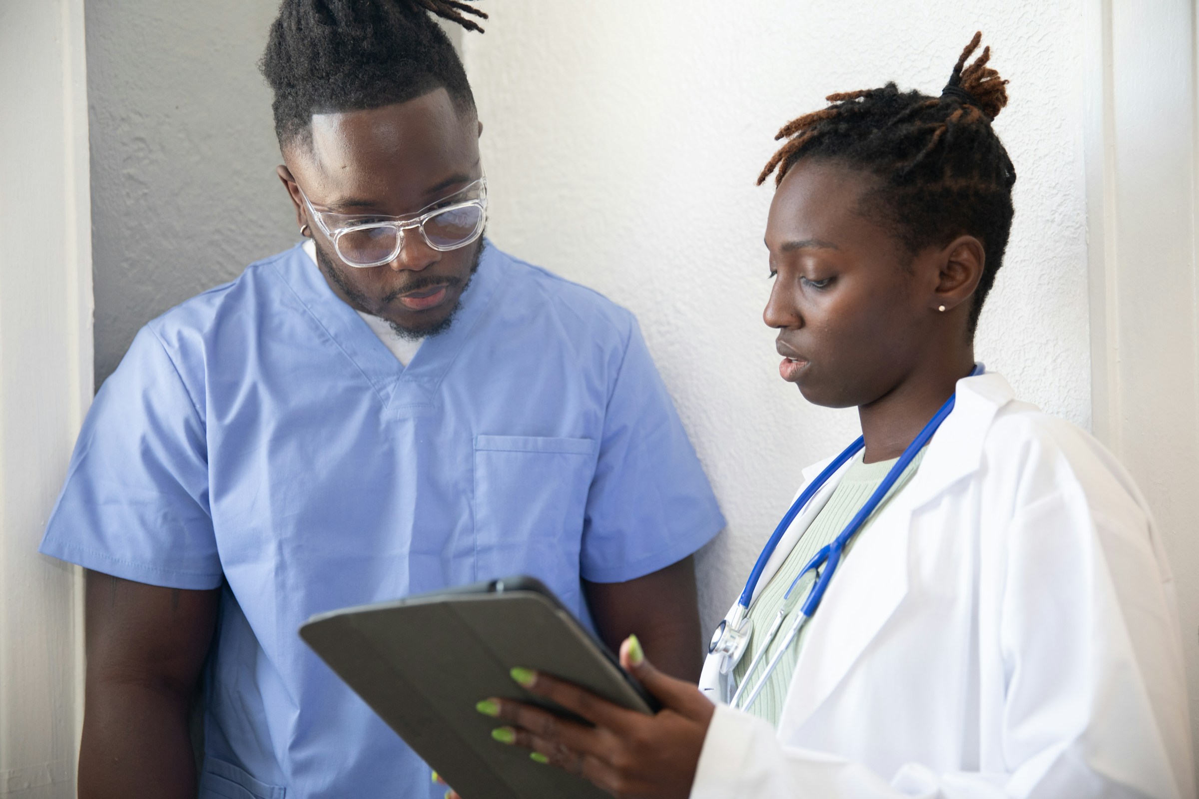 Two providers discuss a tablet. Photo by Nappy on Unsplash